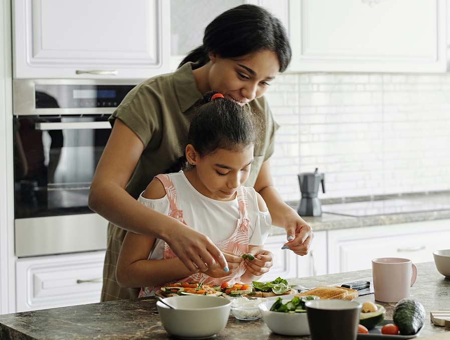 Mother and Daughter Preparing Food