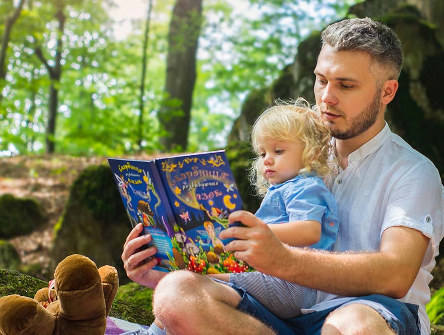 Father and Daughter Reading in the woods