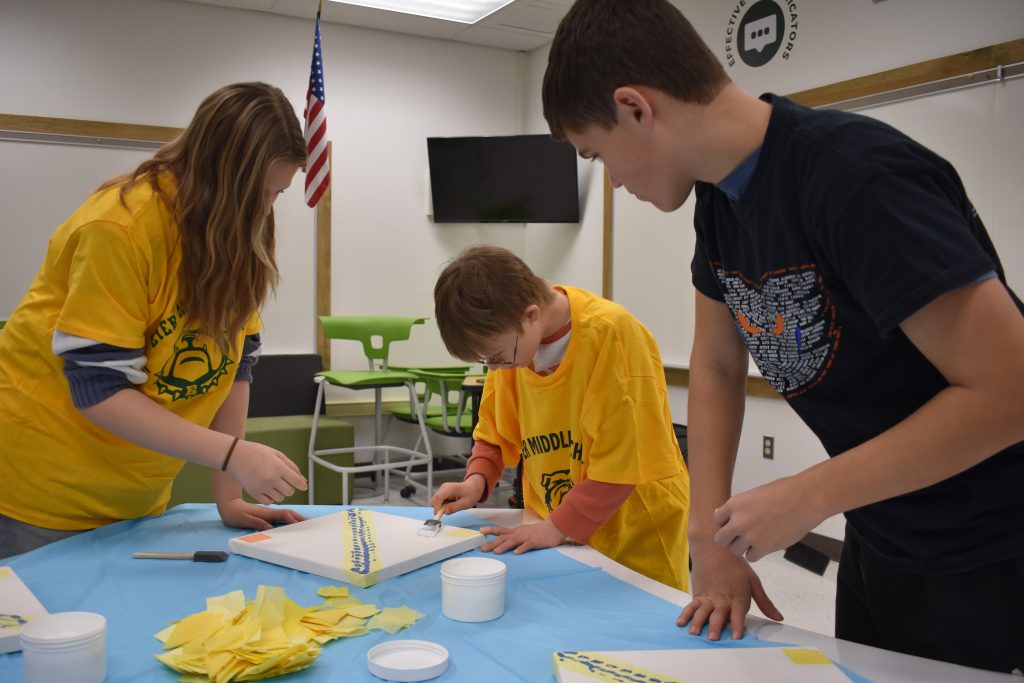 Three Students working on creating a kaleidoscope art installation