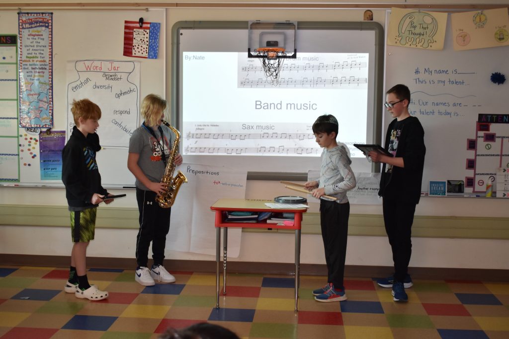 A group of students playing instruments at the Willow Lane 5th grade talent show