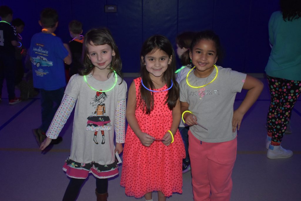 three girls with glow necklaces at the glow dance party