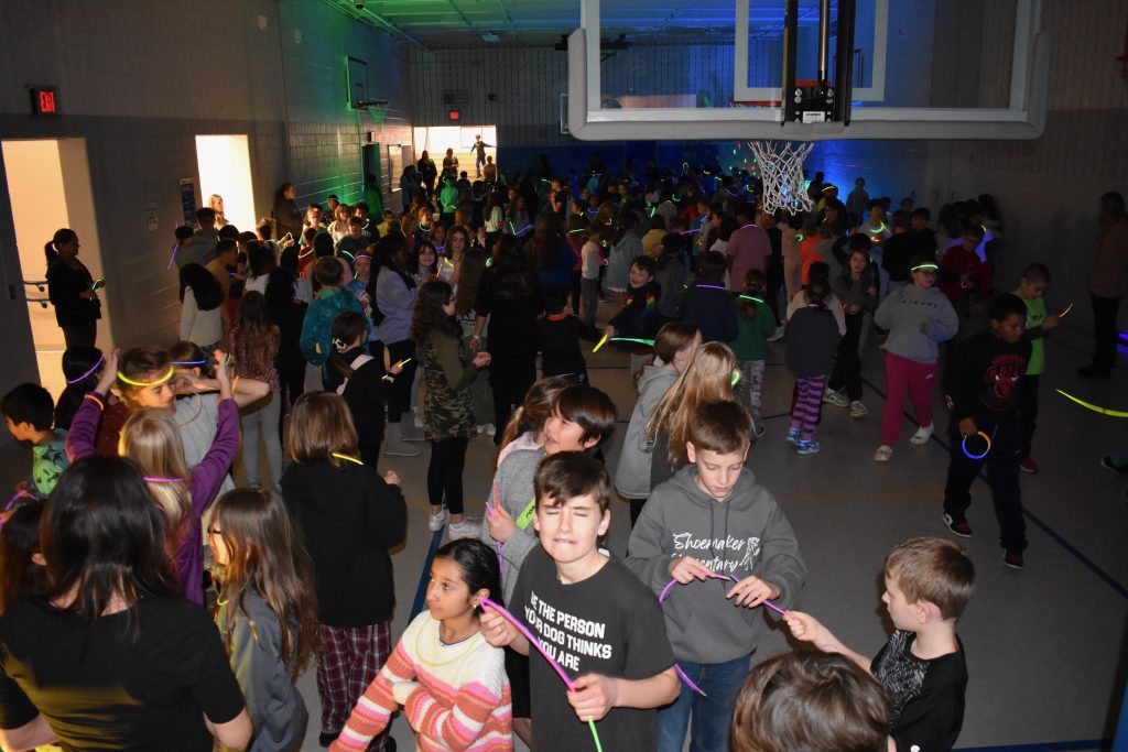 a huge crowd of students at the glow dance party