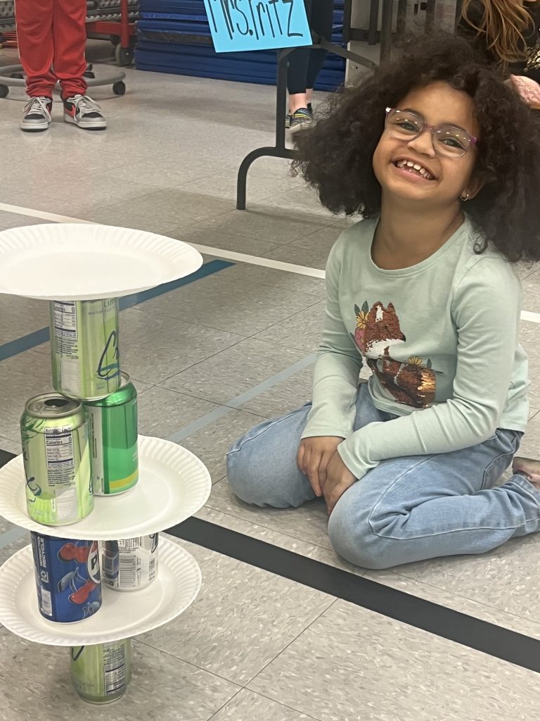 Elementary student girl smiling at the inaugural Minute to Win it games 